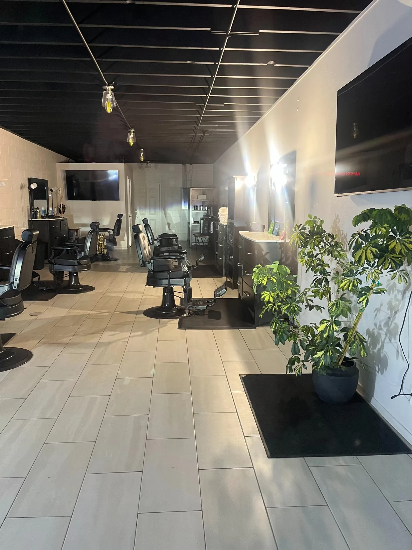 Barber chairs and workstations inside Masters Barber & Shave