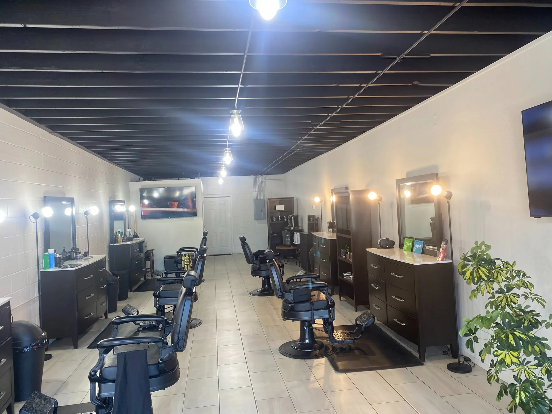 Wide view of the clean barber stations inside Masters Barber & Shave